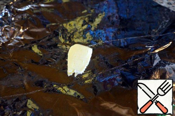 Put a piece of butter on the foil.