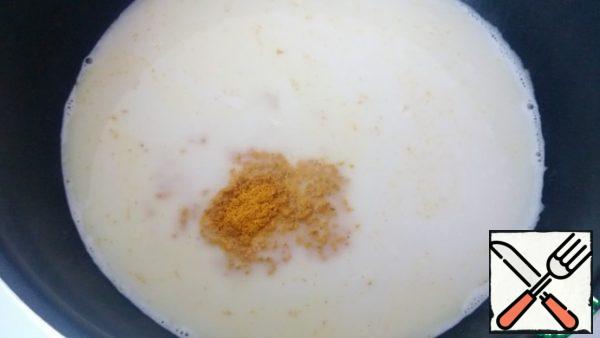 Heat the coconut milk to a boil, but don't boil it. Add the curry powder, mix thoroughly, and let stand under the lid while you cook the rest.