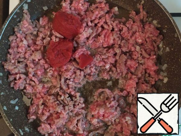 Add tomato paste. Add salt, pepper, chili, paprika, cumin, oregano. Cook for a couple of minutes.