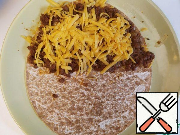 Minced meat on it and cheese on the minced meat again.