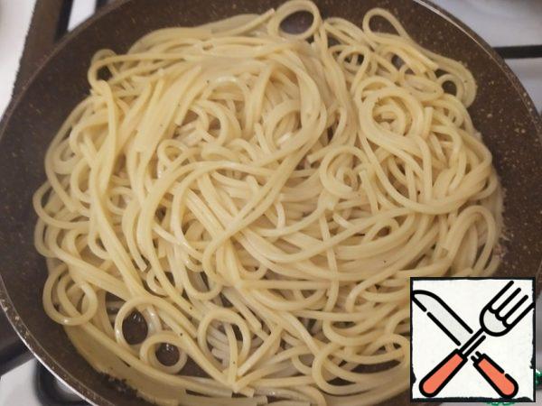 Cacio e pepe we prepare not just to the state of al dente, but to the hard al dente.

So, having reached a hard al dente, transfer the spaghetti to the pan with the pepper. Mix well. Add a little water (literally 0.5-1 ladle). Cook, stirring constantly, for one and a half minutes.