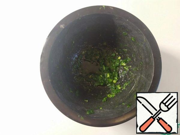In a mortar, grind the garlic into a paste. Add the parsley and also mash. Add salt and olive oil to taste.