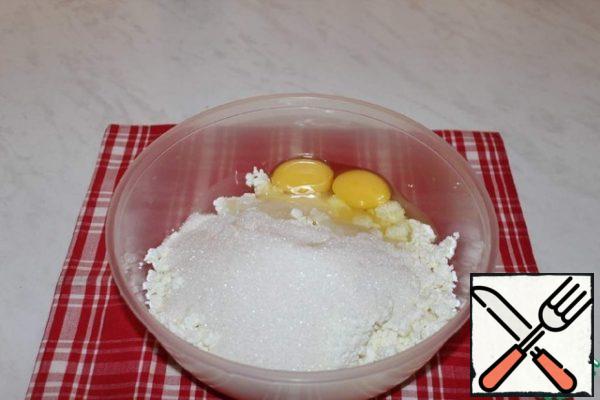Preparing the filling. Add sugar and eggs to the curd. Punch until smooth.