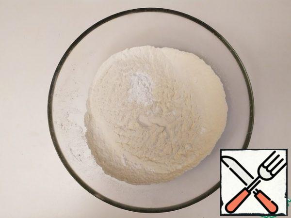 Sift the flour and baking powder. Add soda, salt, and sugar. Stir.