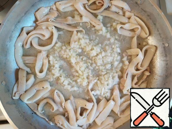 Make a well in the middle, add the onion and garlic, and fry for a couple of minutes.