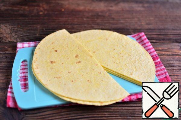 Cut tortillas in half.