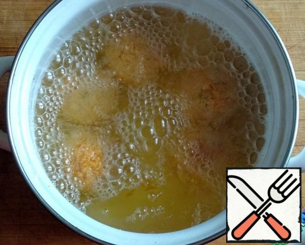Fry the balls in boiling oil until browned, about 6-8 minutes. Using a slotted spoon, remove the balls to a plate covered with napkins to absorb excess oil.