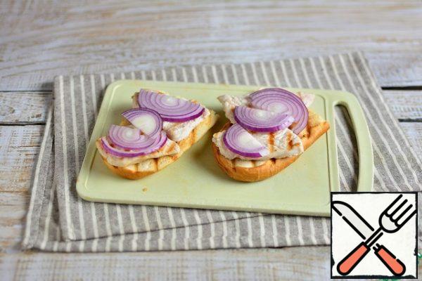 RUB the bread with garlic on both sides, spread the Turkey on the bread, top with thin half-rings of onions.