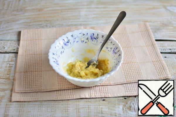 Mash the bananas with a fork.