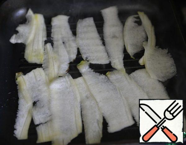 Brush the zucchini slices with butter and lightly grill on both sides.