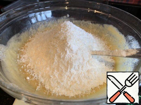 Add flour, baking powder and coconut flakes. Knead until the dough is smooth.