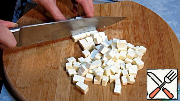 Cut the cheese into small cubes.