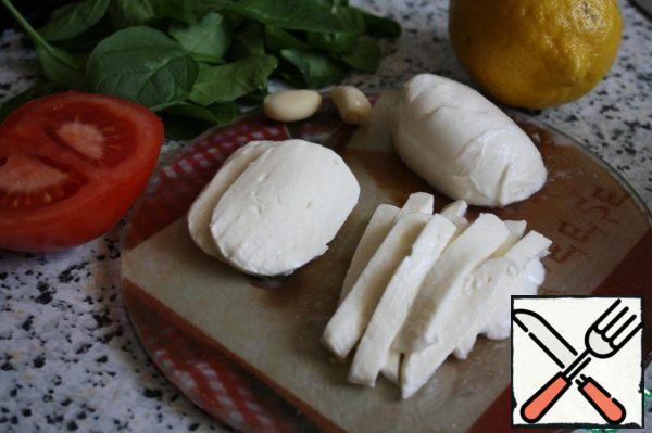 Cut the mozzarella into thin slices or strips.