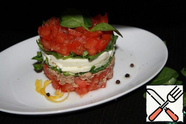 Lay out the layers in the serving ring;
tomatoes
tuna
Basil
mozzarella
Basil
tomatoes.
Sprinkle with ground pepper and you can serve!
P.S. If you do not have a serving ring for salads, you can use a plastic milk bottle, pre-cut it. Or take a square box of kefir, doing the same manipulations with it)). Be sure to smear the inside of it with vegetable oil: the salad will slide and will not crumble when removed from the mold.