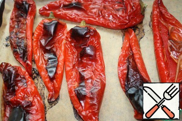 Bake the peppers on the grill or in a very hot oven at 200 degrees for about 30 minutes, until the skin turns black.