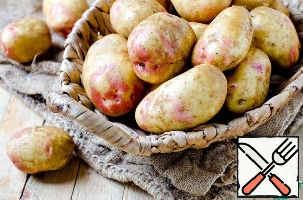 Wash the potatoes and boil them in their uniforms in boiling salted water until they are half cooked.
