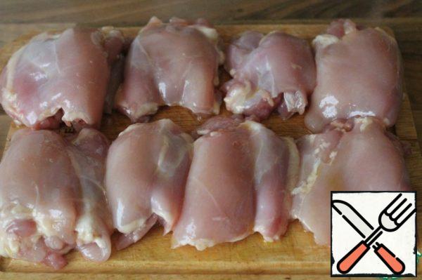 Wash the chicken thighs, dry them, and brush them with olive oil.