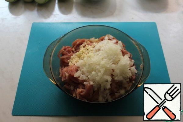 Add finely chopped onion and garlic to the minced meat.