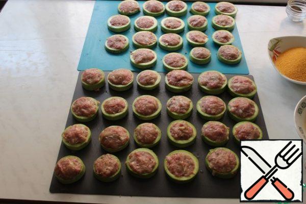 Each ring of zucchini stuffed with minced meat.
