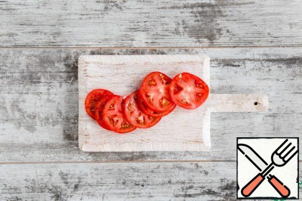 Preheat the oven to 170 °C. Thinly slice the tomato.