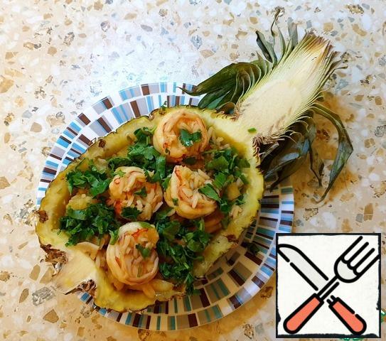 Put in half a pineapple and garnish with chopped coriander.