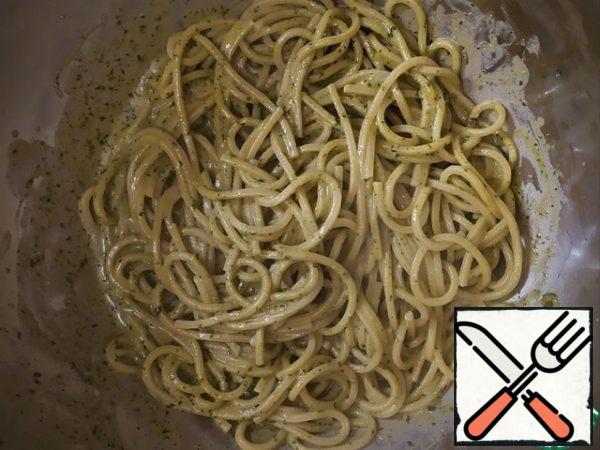 We take out the spaghetti and mix it in the sauce.