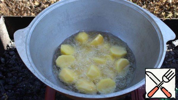 In a large amount of vegetable oil, fry the potatoes until Golden brown. Add a little salt.