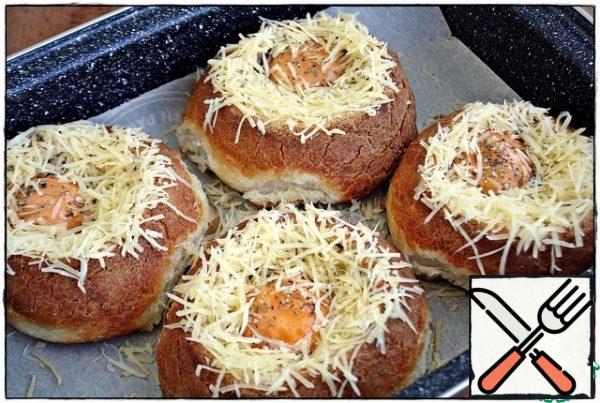 Grate the cheese on a fine grater, spread it on the side in a circle, leaving the yolk open, send the buns to the oven, preheated to 190 degrees. The baking time depends on the desired readiness of the yolk, I like it runny and kept it in the oven for 15 minutes, if you like it more browned, then 20 minutes will be enough. But it all depends on your oven, you need to keep an eye on it...