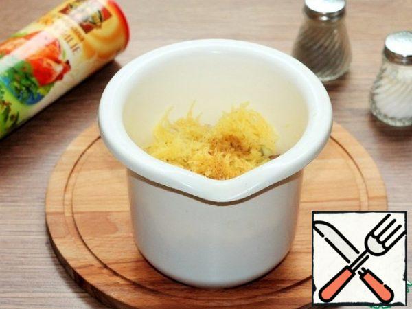 Grated peeled raw potatoes on a medium grater. 