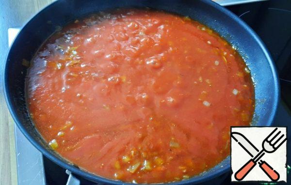 Add the sauteed tomatoes and 2 tablespoons of adjika, bring to a boil, and simmer for 20 minutes, stirring occasionally.