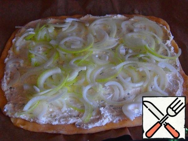 Cut three medium-sized onions into rings or half rings. Spread the onion over the surface of the pie.