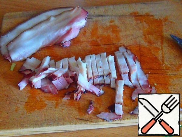 Cut the bacon into strips.