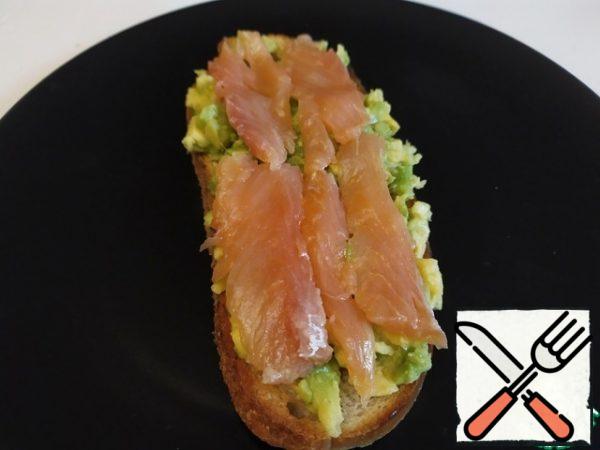 Put the fish on the avocado.