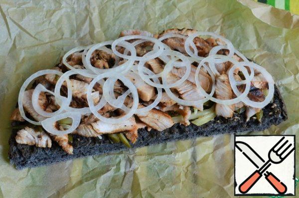 Put the sliced grilled Turkey on the cucumbers and onion rings on it.