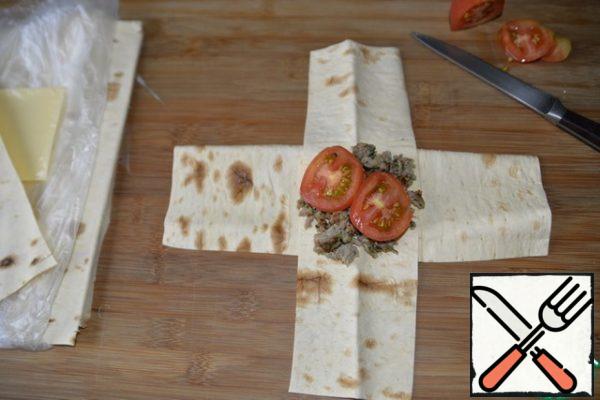 Put 2-3 thin circles of tomatoes on the minced meat for juiciness.