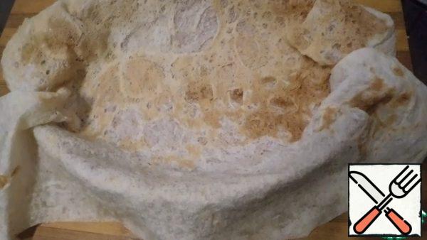Moisten the pita bread with a little water to make it easier to work with. In a form (for 2 servings) oiled put pita bread, you can put two layers down. The edges of the pita bread should hang down.

Since there are different types of pita bread, repeat the recipe if you are sure of the plasticity of your pita bread and have experience with it.