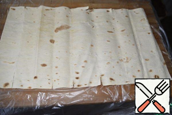 Take a sheet of pita bread, I have a wheat roll, it is thinner than pita bread and longer.