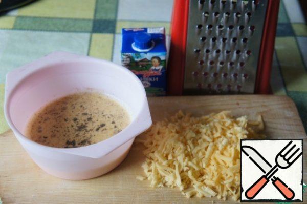 Put the filling ingredients in a bowl, add salt and pepper to taste, and beat lightly with a whisk. Grate the cheese on a coarse grater.