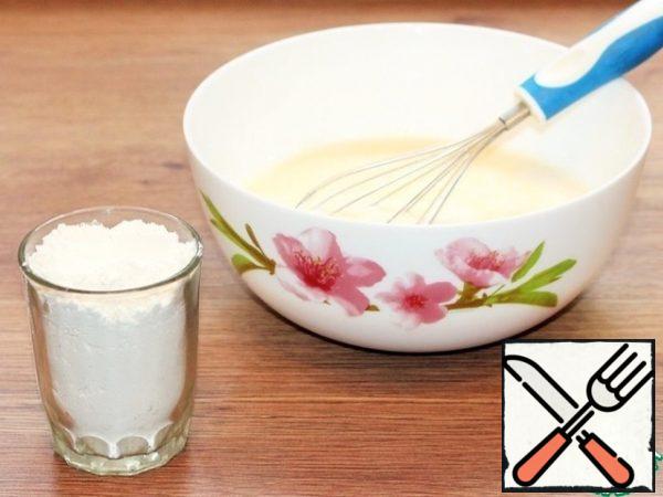 Sift the flour into a bowl in small portions. Knead the dough with a whisk or beat with a mixer until smooth without lumps.