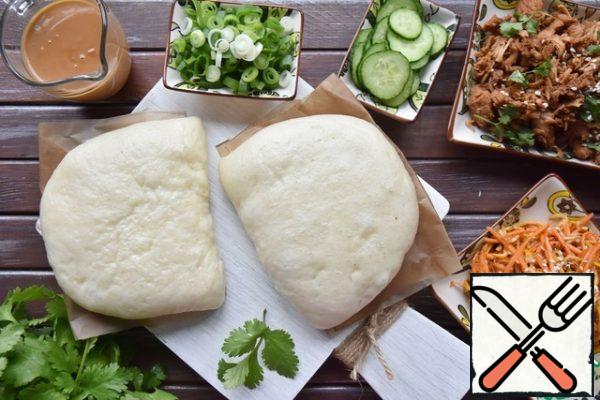 For the sauce, mix and warm the peanut paste with soy sauce and water. Stir the sauce until smooth and pour into a saucepan.
Assemble all the components to build gua Bao.
