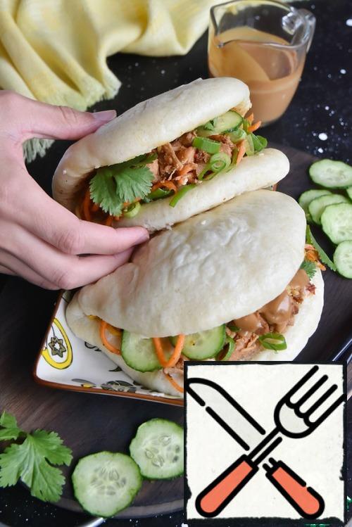 Remove the paper from the rolls. Fill the pockets with pieces of baked Turkey, peanut sauce, lettuce, cucumber slices, green onion rings and coriander.