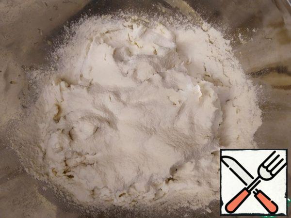Start gradually adding flour and knead the dough.