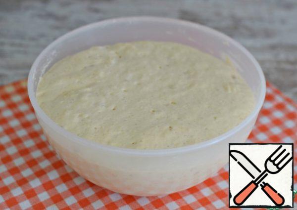 The dough should increase in volume by 2.5-3 times.
Using a cooking spatula or spoon, knead the dough right in the bowl.