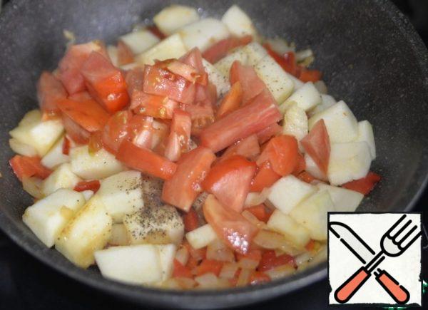 Cut the tomato into cubes, add it to the vegetables, and simmer for 3 minutes over medium heat.