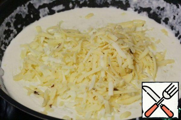 Stirring constantly, bring the cream mixture to a boil and, as soon as it begins to thicken, remove the pan from the heat.
Add the grated cheese (I have mozzarella and semi-hard cheese with chanterelles) and mix.