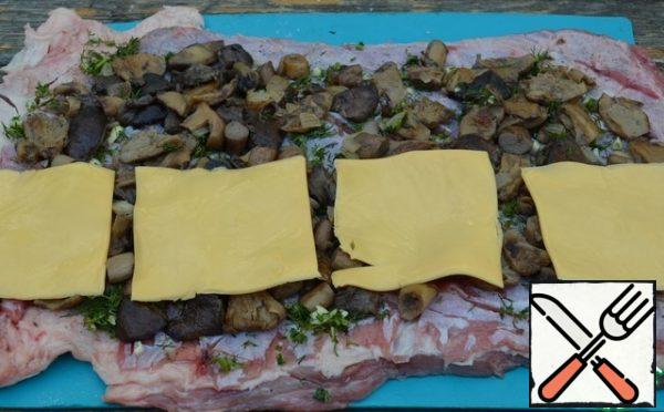 On one side, spread out the plates of melted cheese.