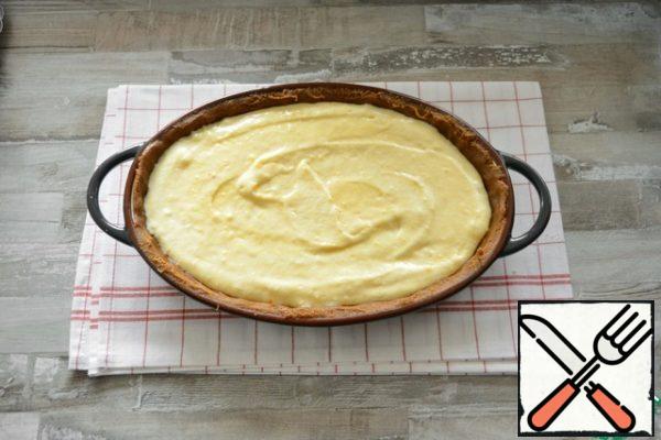 Pour the cheese souffle into the mold and smooth it out with a spatula.