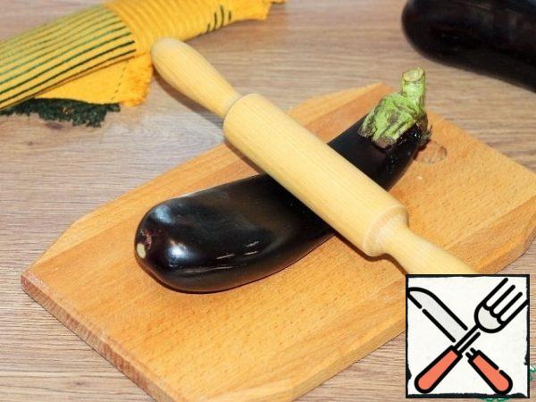 Carefully roll out the eggplant with a rolling pin until soft...