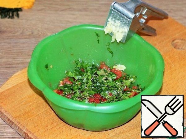 Add the peeled and pressed garlic, chopped herbs, ground coriander and mix.