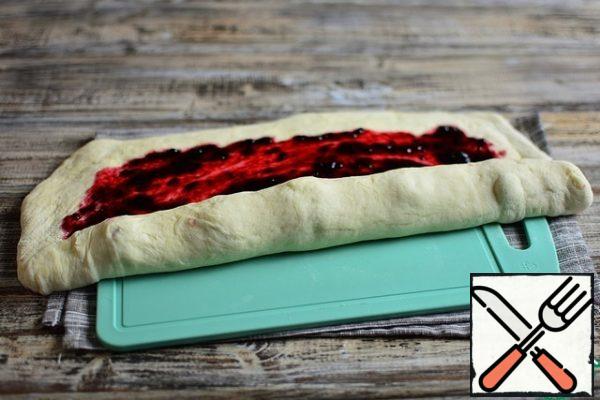 On the berry side, wrap the dough in a roll. Pinch the edges.